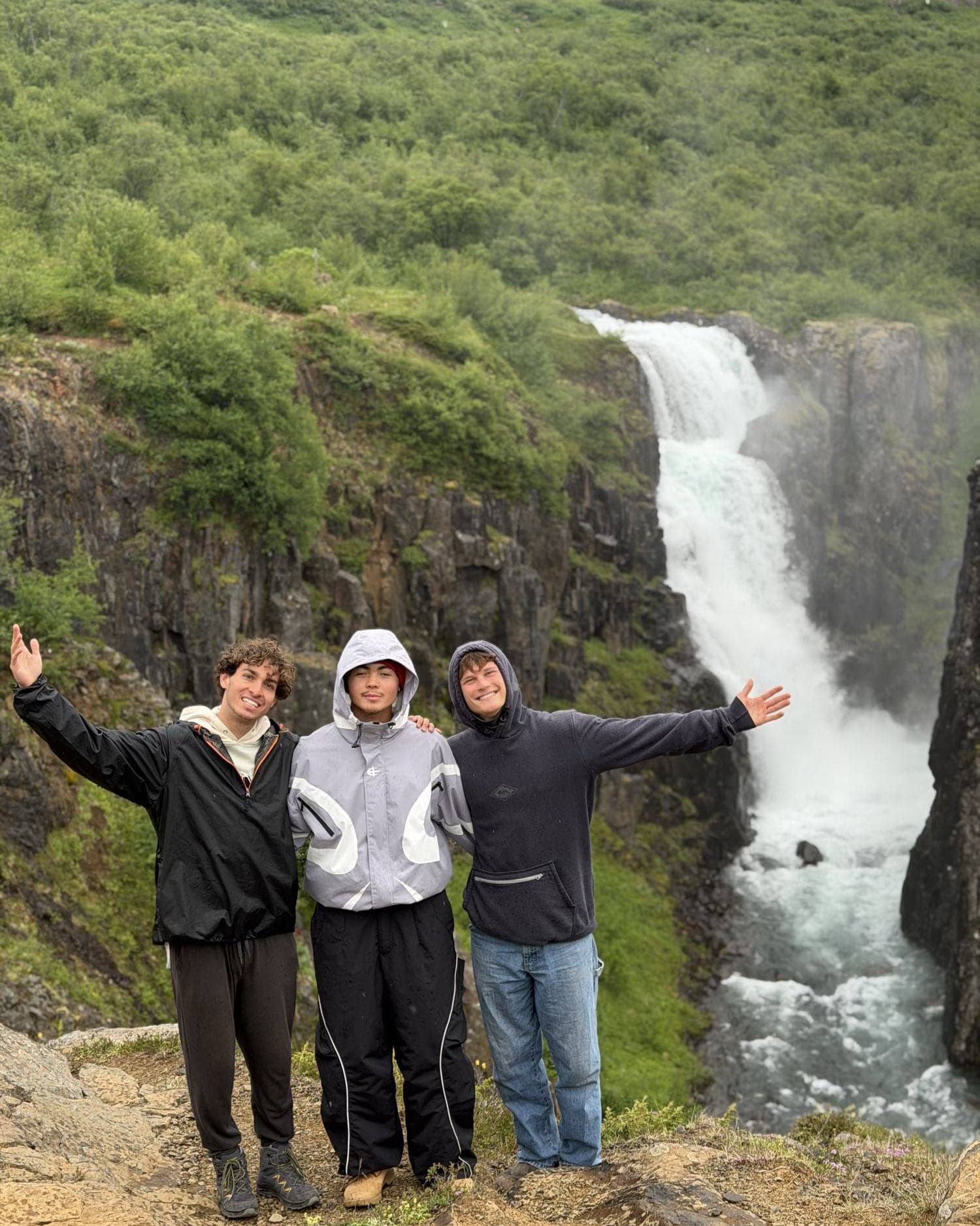 The crew and new friends celebrating at an insane waterfall