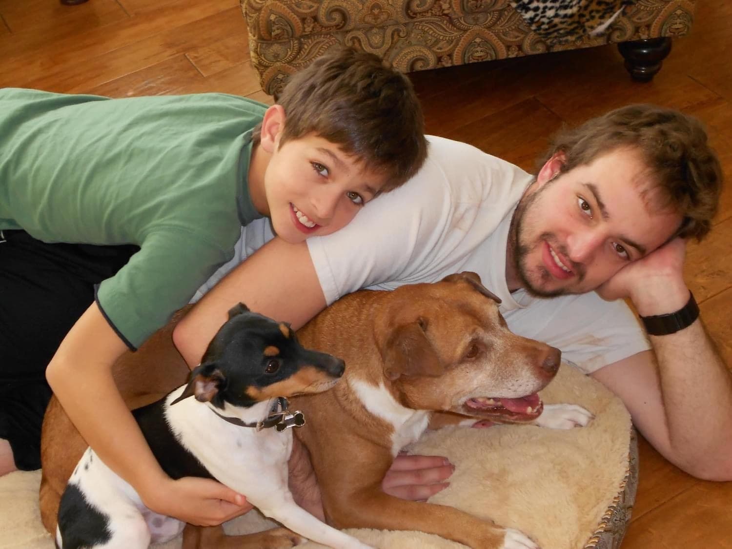 Auzi and his brother at home with their dogs
